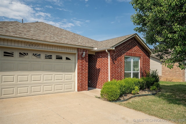 single story home with a garage and a front yard