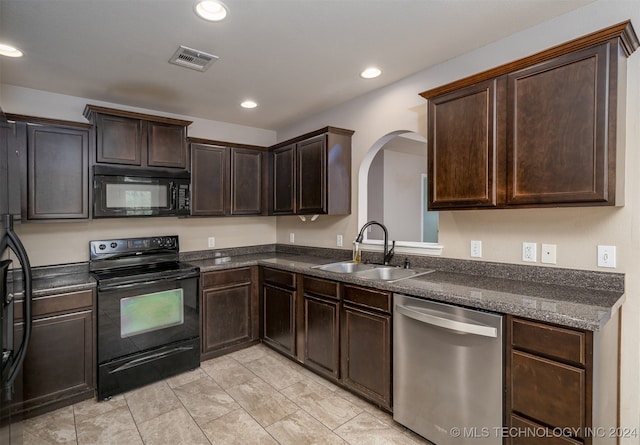 kitchen with dark brown cabinets, black appliances, and sink