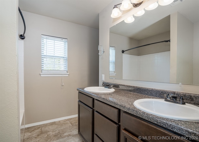 bathroom with vanity and shower / washtub combination