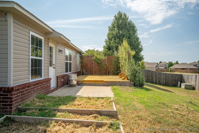 view of yard with a deck and a patio