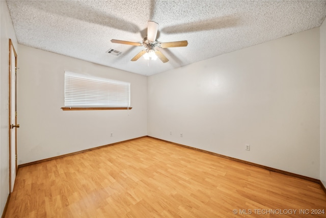 unfurnished room featuring ceiling fan, a textured ceiling, and light hardwood / wood-style floors