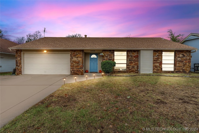 ranch-style home with a yard