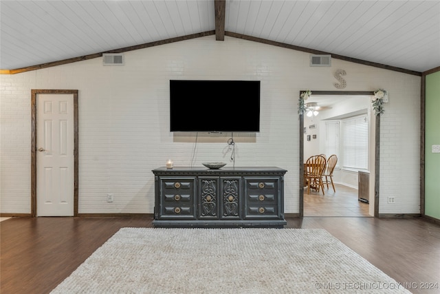 living room with vaulted ceiling with beams, dark hardwood / wood-style floors, wooden ceiling, and brick wall