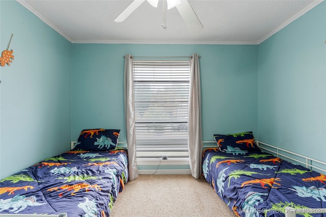 bedroom with ceiling fan, carpet floors, a textured ceiling, and ornamental molding