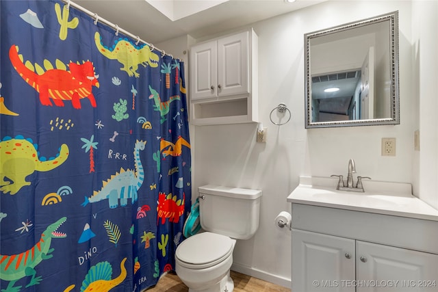 bathroom with hardwood / wood-style floors, vanity, toilet, and walk in shower