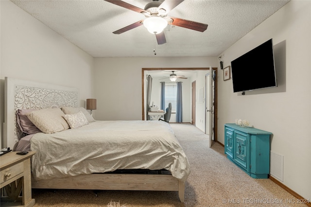 carpeted bedroom featuring a textured ceiling and ceiling fan