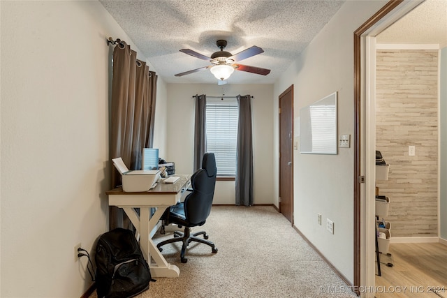 office with light carpet, a textured ceiling, ceiling fan, and wood walls