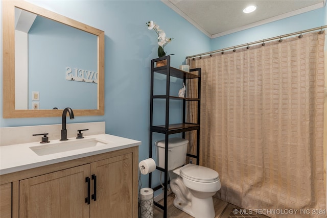 bathroom featuring walk in shower, crown molding, vanity, and toilet