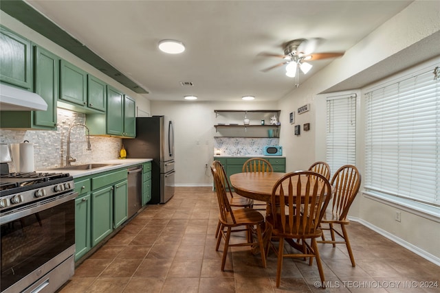 kitchen featuring ceiling fan, sink, green cabinetry, and appliances with stainless steel finishes