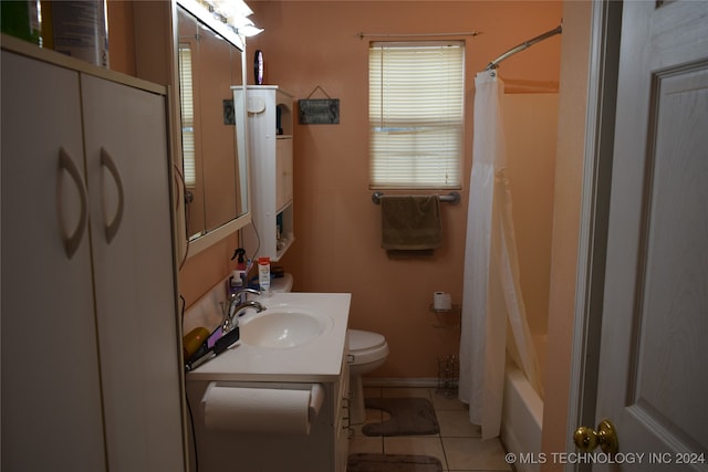 full bathroom featuring toilet, shower / tub combo with curtain, vanity, and tile patterned floors