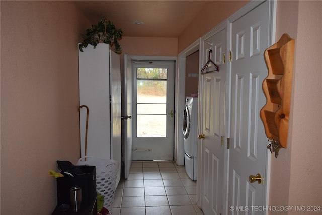 doorway featuring light tile patterned floors and washer / clothes dryer