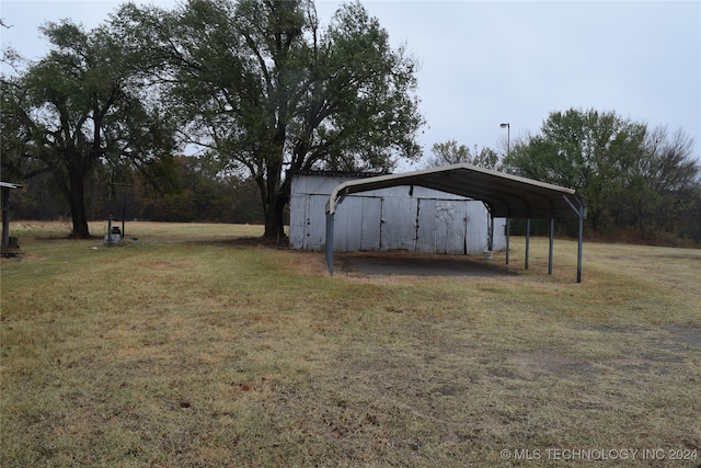 view of outdoor structure featuring a carport and a yard