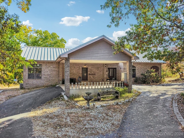 view of front of home with a porch and cooling unit