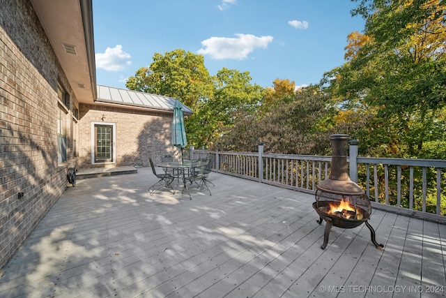 wooden terrace with a fire pit