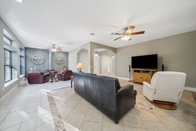 living room with ceiling fan and light tile patterned floors