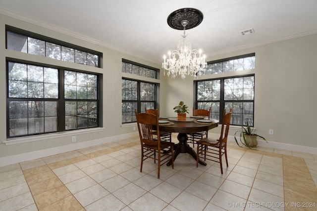 tiled dining space with ornamental molding, a wealth of natural light, and a chandelier