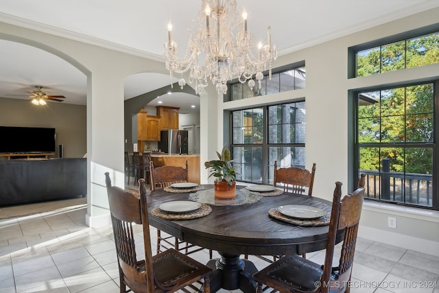 tiled dining space with ceiling fan with notable chandelier and crown molding