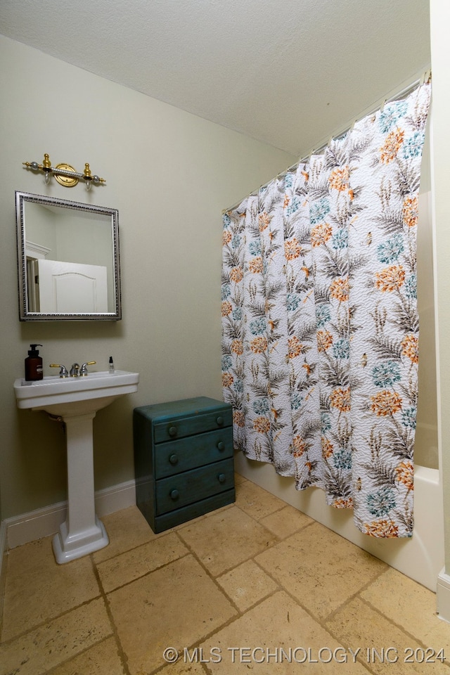 bedroom featuring beamed ceiling and ceiling fan