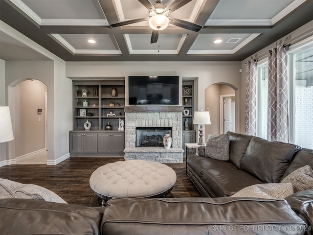 living room with coffered ceiling, dark hardwood / wood-style floors, ceiling fan, beam ceiling, and a fireplace