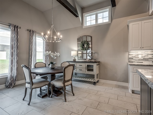 dining area with a wealth of natural light, beamed ceiling, high vaulted ceiling, and a notable chandelier