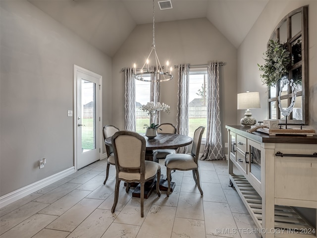 dining area featuring a wealth of natural light, an inviting chandelier, and lofted ceiling