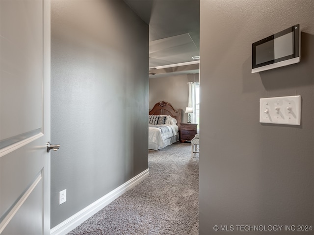 corridor with light colored carpet