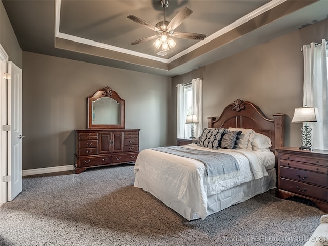 bedroom featuring carpet flooring, ceiling fan, and a raised ceiling