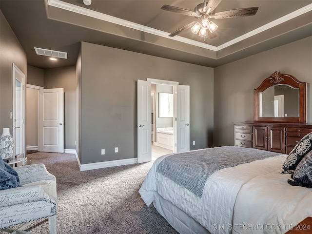 bedroom featuring connected bathroom, light colored carpet, ceiling fan, and a raised ceiling