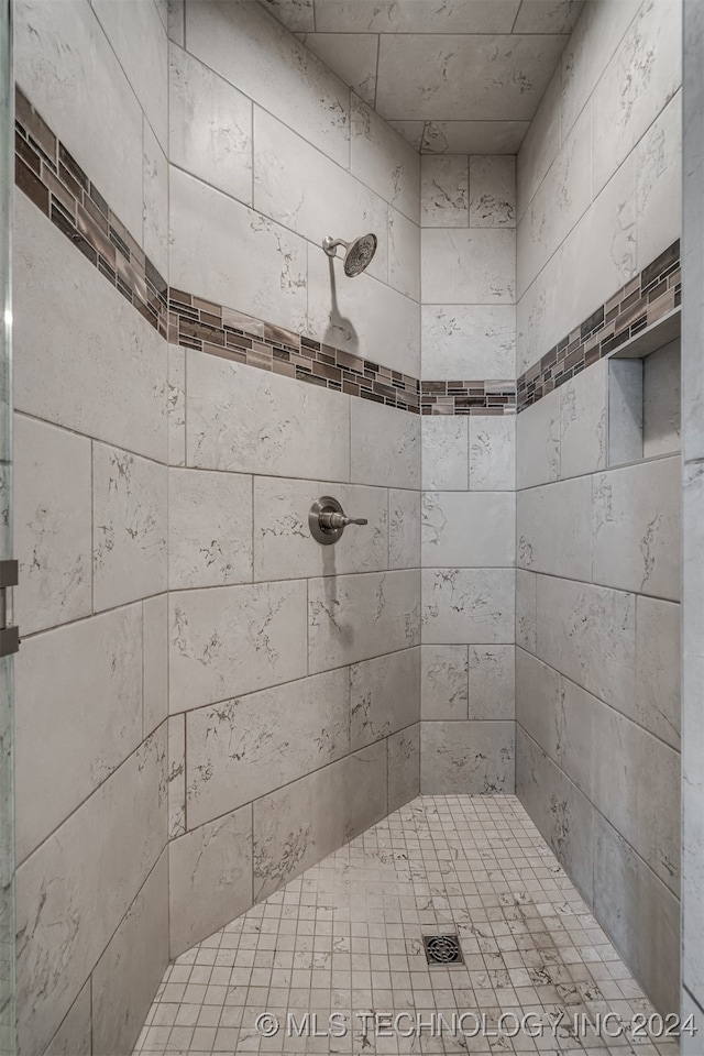 bathroom with tiled shower