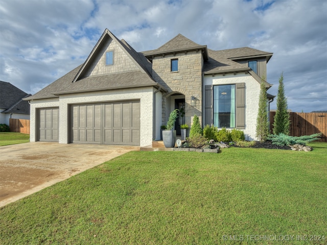 view of front of property with a front lawn and a garage