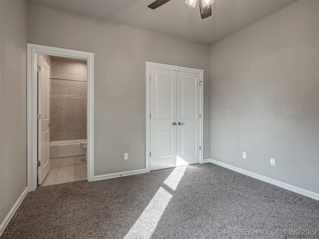 unfurnished bedroom with ensuite bathroom, ceiling fan, light carpet, and a closet