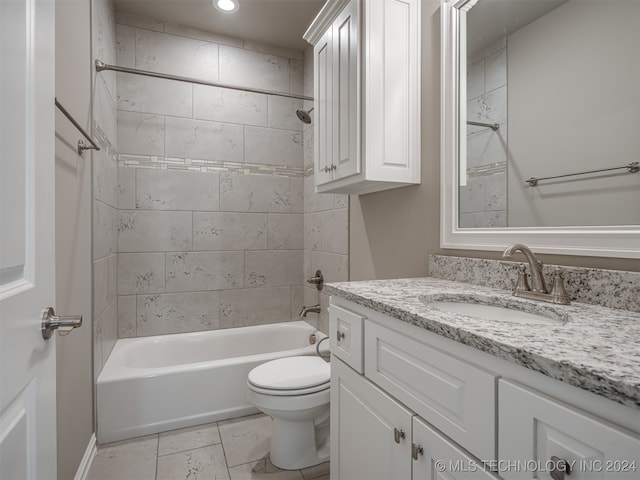 full bathroom with toilet, vanity, and tiled shower / bath