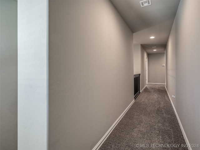 hallway with dark carpet