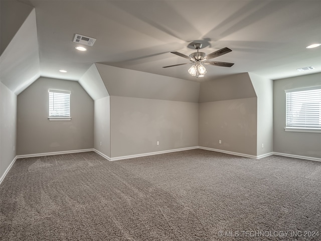 additional living space with ceiling fan, lofted ceiling, and carpet