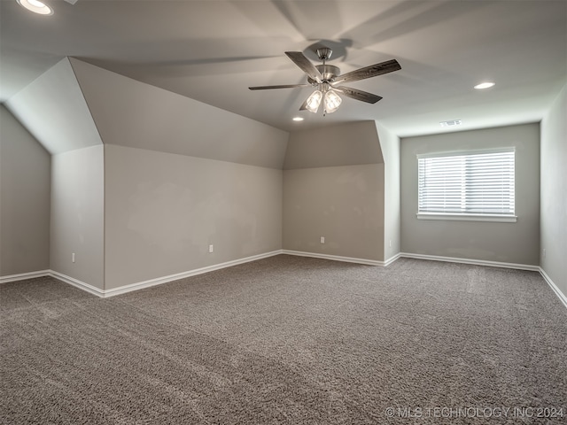 additional living space featuring lofted ceiling, carpet flooring, and ceiling fan