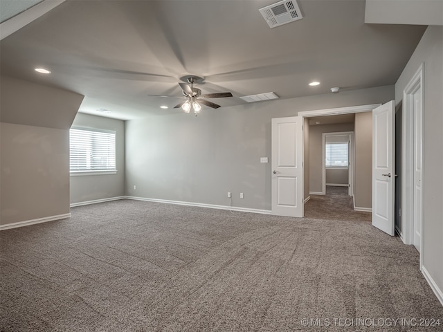 carpeted empty room featuring ceiling fan