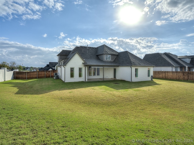 rear view of house with a yard