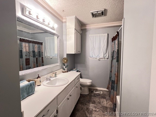 bathroom featuring vanity, ornamental molding, toilet, and a textured ceiling