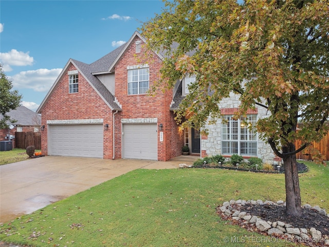 view of front of house featuring central air condition unit, a garage, and a front lawn