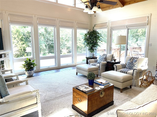 interior space featuring beamed ceiling, ceiling fan, and plenty of natural light