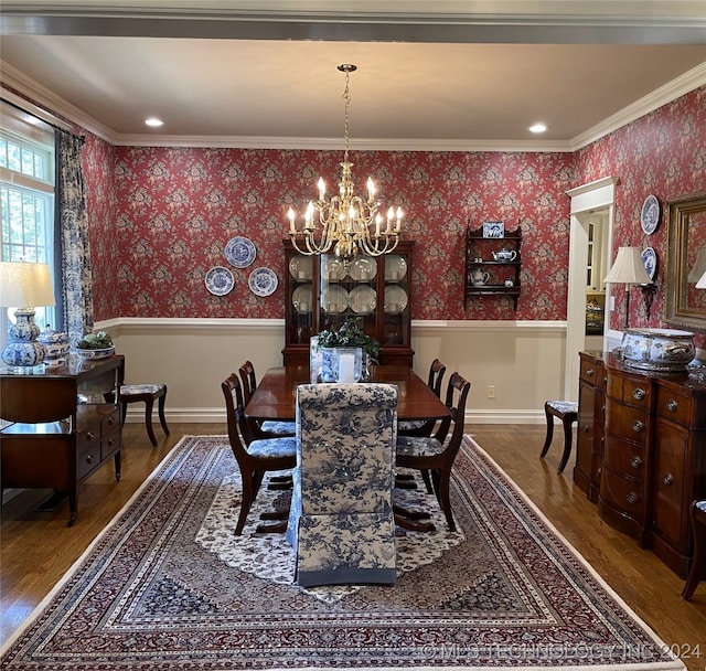 dining room with a chandelier, hardwood / wood-style flooring, and crown molding