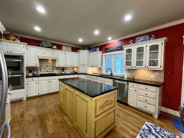 kitchen featuring white cabinets, stainless steel appliances, and a kitchen island