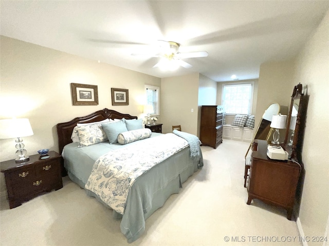 bedroom with light colored carpet and ceiling fan