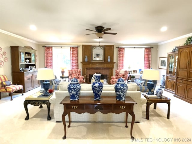 carpeted living room with a brick fireplace, a wealth of natural light, and crown molding