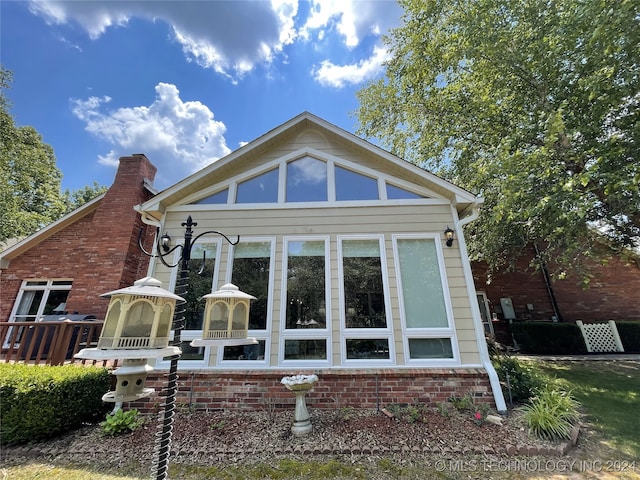 back of house featuring a sunroom