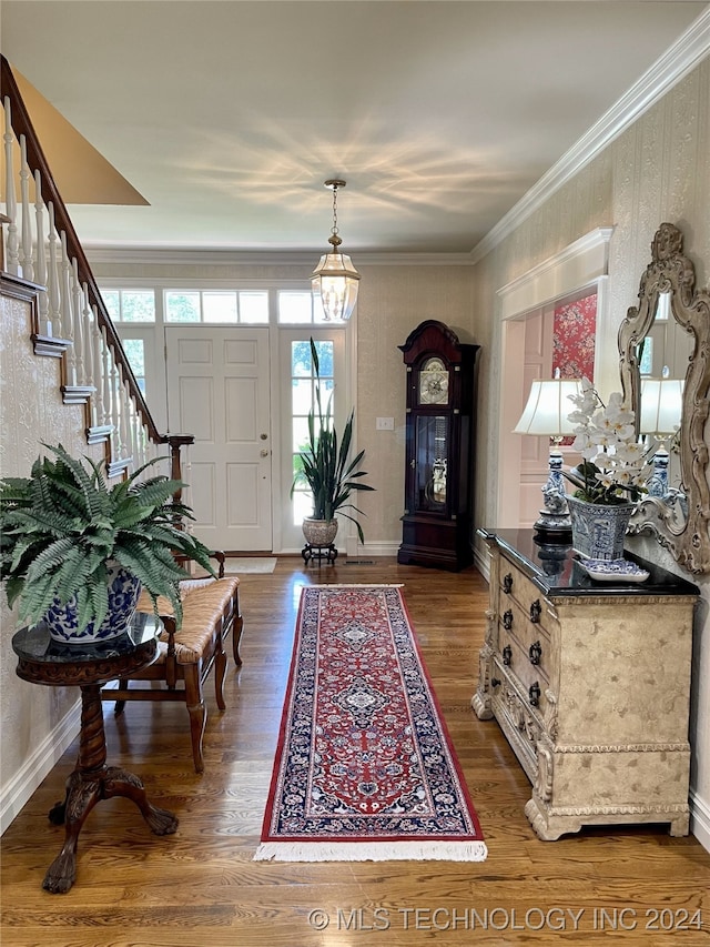 foyer featuring dark hardwood / wood-style flooring and ornamental molding