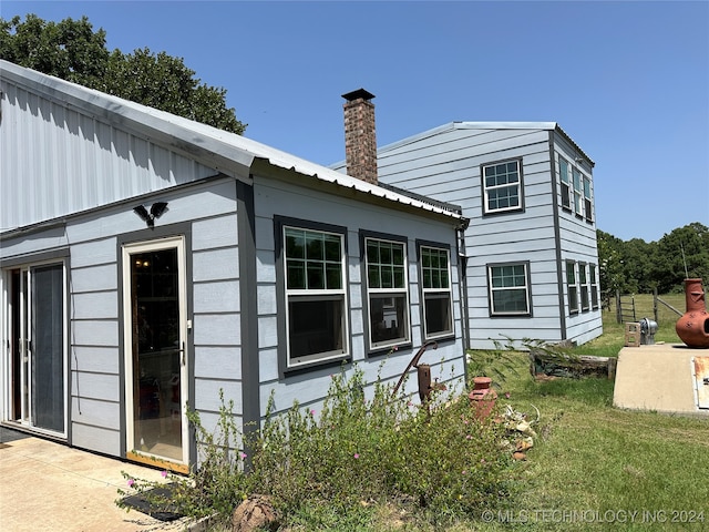 rear view of property with a lawn