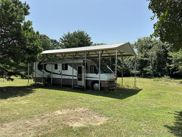 view of parking / parking lot with a lawn and a carport