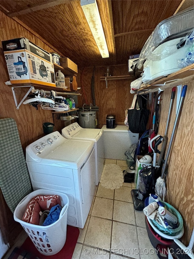 laundry area with wood walls, washing machine and dryer, and wood ceiling