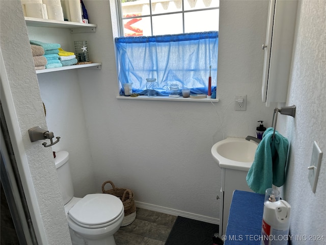 bathroom featuring toilet and vanity